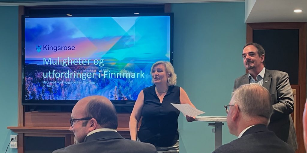 Anita Hall fra Norsk Bergindustri og Brede Edvardsen fra Norsk Arbeidsmandsforbund står foran en skjerm som viser teksten "Kingsrose - Muligheter og utfordringer i Finnmark" under et møte. Flere personer sitter i forgrunnen og lytter. Foto tatt i et moderne møterom.